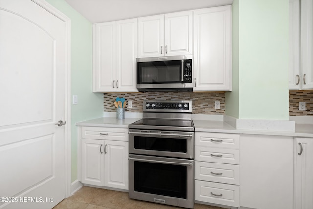 525 3rd St N Unit 303, Jacksonville Beach, FL 32250 - kitchen with stainless steel appliances, light countertops, and white cabinets