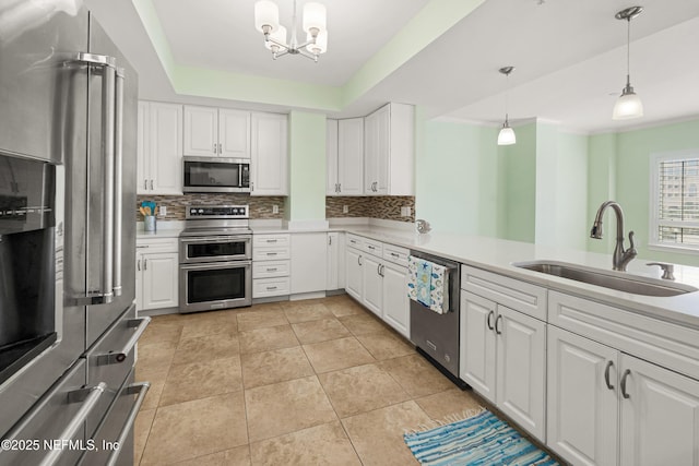 525 3rd St N Unit 303, Jacksonville Beach, FL 32250 - kitchen featuring light countertops, appliances with stainless steel finishes, backsplash, and a sink