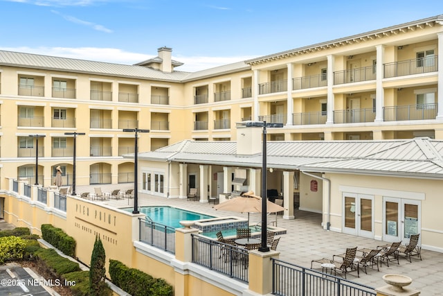 525 3rd St N Unit 303, Jacksonville Beach, FL 32250 - view of pool featuring french doors, a patio area, and a pool with connected hot tub