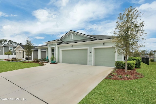 view of front of property featuring driveway, roof with shingles, an attached garage, fence, and a front lawn