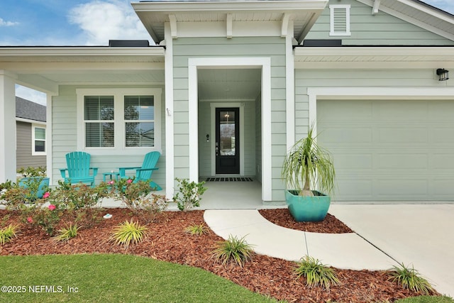 doorway to property with a garage and a porch