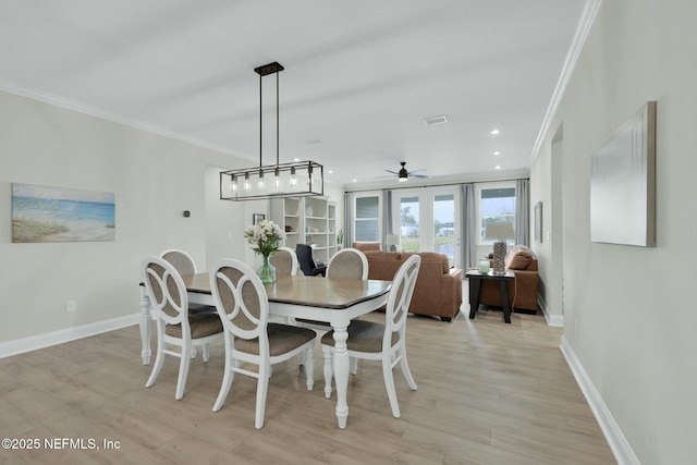 dining space with ornamental molding, recessed lighting, light wood-style floors, and baseboards