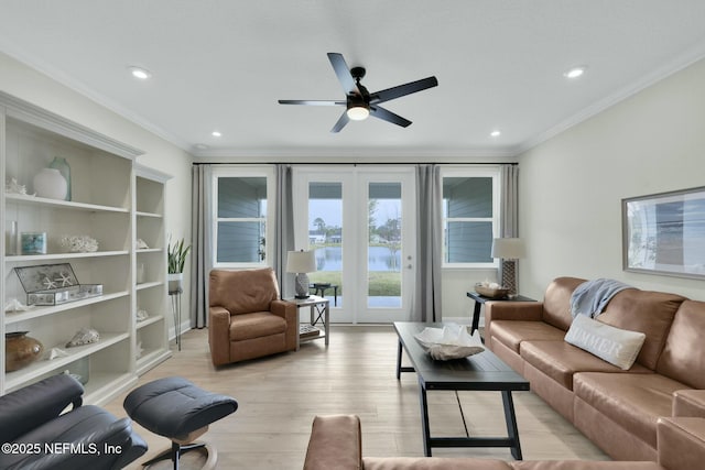 living room featuring recessed lighting, a ceiling fan, built in features, ornamental molding, and light wood-type flooring