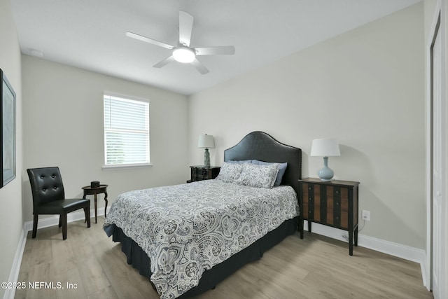 bedroom featuring wood finished floors, a ceiling fan, and baseboards