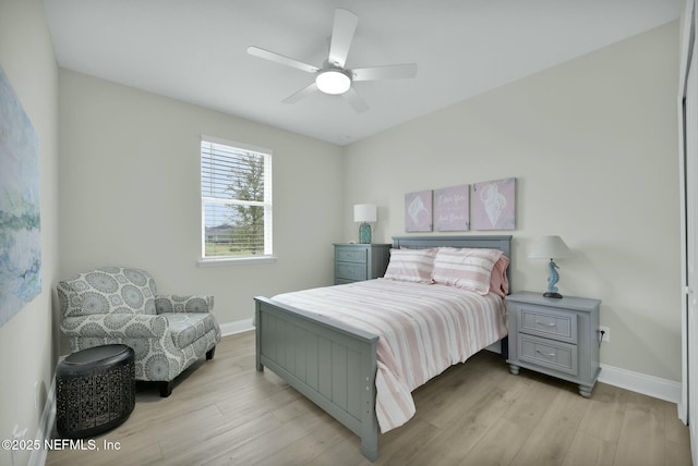 bedroom featuring light wood-type flooring, ceiling fan, and baseboards