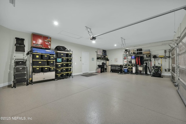 garage with a garage door opener and baseboards