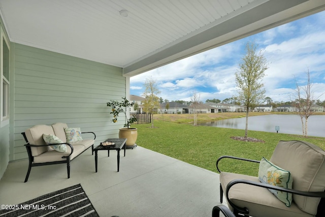 view of patio featuring an outdoor living space, a water view, and a residential view