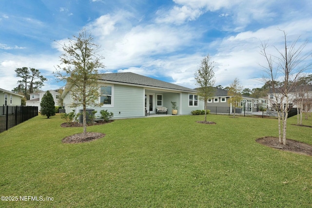 back of property featuring a fenced backyard, a lawn, and a patio