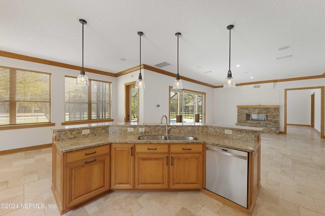 kitchen featuring dishwasher, stone tile floors, a fireplace, a textured ceiling, and a sink