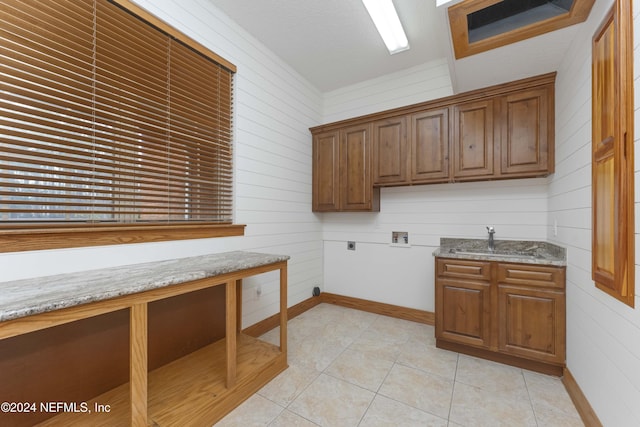 washroom with washer hookup, light tile patterned floors, cabinet space, hookup for an electric dryer, and a sink