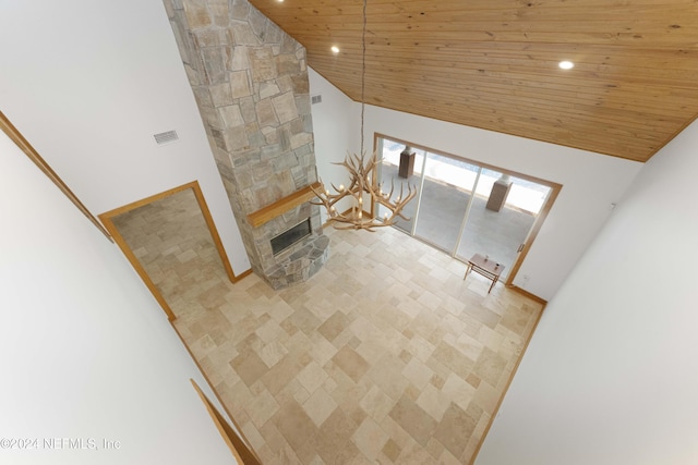 living room with a stone fireplace, wooden ceiling, recessed lighting, and high vaulted ceiling