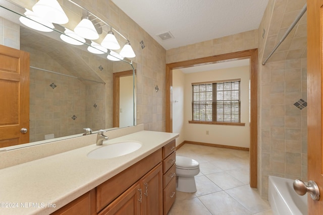 bathroom with tile patterned floors, visible vents, toilet, a tile shower, and tile walls