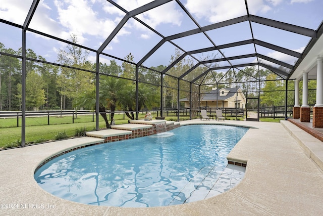 pool with glass enclosure and a patio