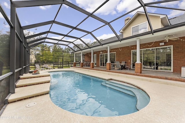 outdoor pool featuring a patio, a lanai, and ceiling fan