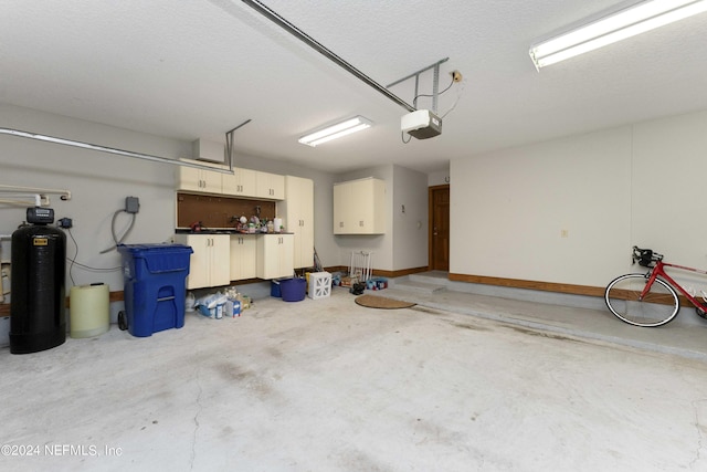 garage featuring a garage door opener and baseboards