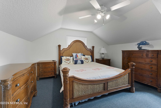 bedroom featuring dark carpet, a textured ceiling, lofted ceiling, and a ceiling fan