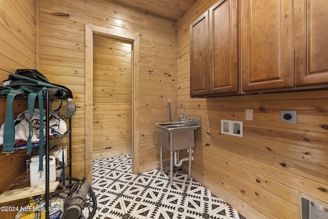 washroom with wooden walls, cabinet space, electric dryer hookup, and washer hookup