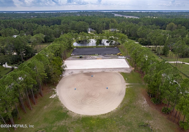 birds eye view of property featuring a view of trees