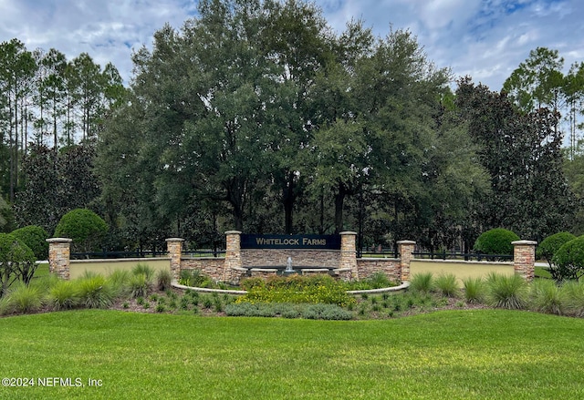 community / neighborhood sign with a lawn