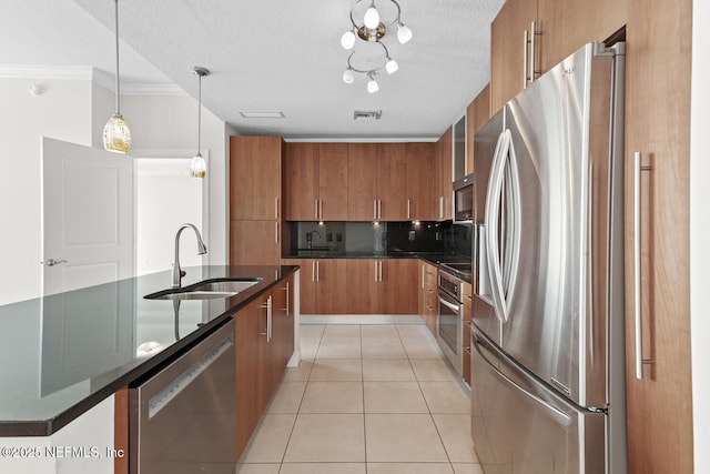 1431 Riverplace Blvd Unit 2606, Jacksonville, FL 32207 - kitchen featuring light tile patterned flooring, a sink, brown cabinets, and appliances with stainless steel finishes