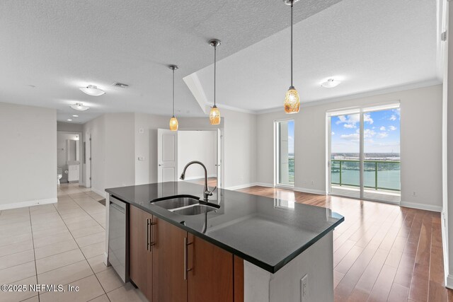 1431 Riverplace Blvd Unit 2606, Jacksonville, FL 32207 - kitchen featuring open floor plan, stainless steel dishwasher, a sink, dark countertops, and visible vents