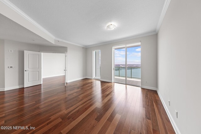 1431 Riverplace Blvd Unit 2606, Jacksonville, FL 32207 - empty room featuring dark wood finished floors, baseboards, ornamental molding, and a textured ceiling