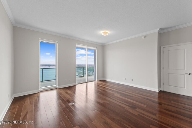 1431 Riverplace Blvd Unit 2606, Jacksonville, FL 32207 - empty room featuring baseboards, ornamental molding, dark wood-type flooring, and a textured ceiling