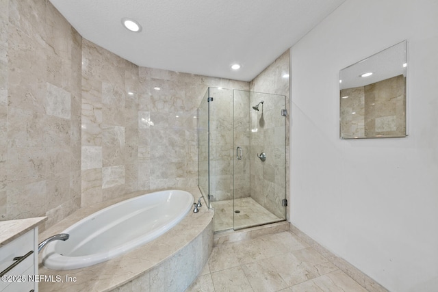 1431 Riverplace Blvd Unit 2606, Jacksonville, FL 32207 - full bath with vanity, a garden tub, a shower stall, baseboards, and recessed lighting