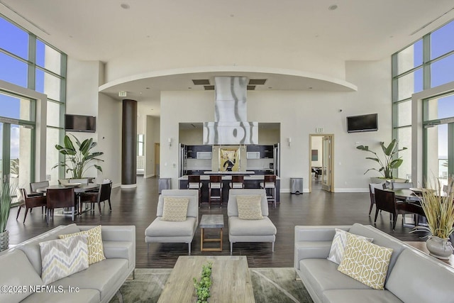 1431 Riverplace Blvd Unit 2606, Jacksonville, FL 32207 - living area featuring wood finished floors, arched walkways, baseboards, and a wall of windows