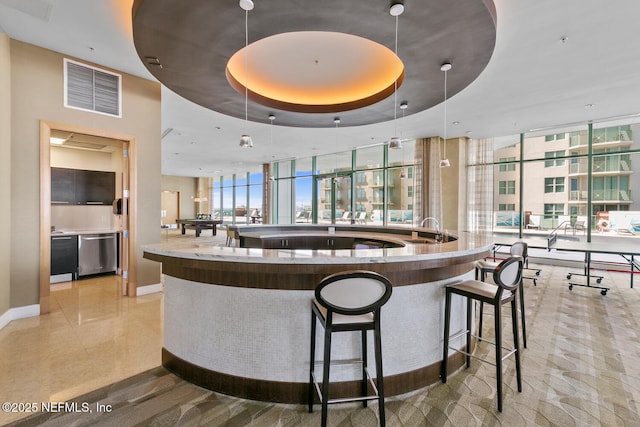 1431 Riverplace Blvd Unit 2606, Jacksonville, FL 32207 - bar featuring stainless steel dishwasher, a wall of windows, visible vents, and a tray ceiling