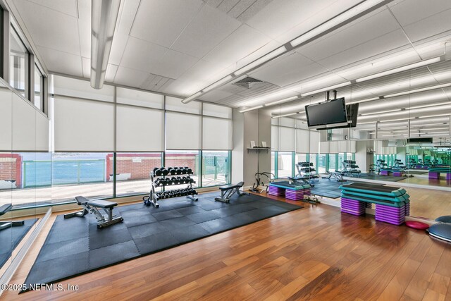 1431 Riverplace Blvd Unit 2606, Jacksonville, FL 32207 - gym with a high ceiling, a wall of windows, and wood finished floors