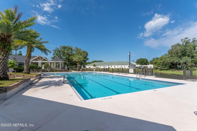 pool with a gazebo, a patio, and fence