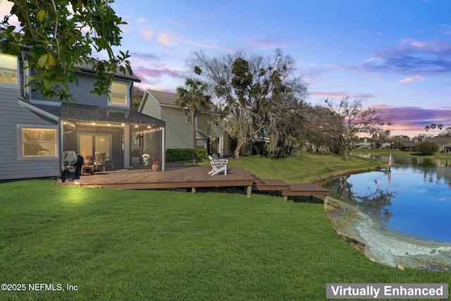 view of yard with a deck with water view