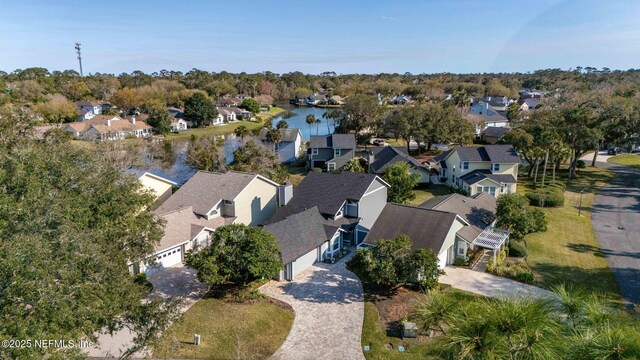 drone / aerial view featuring a residential view and a water view