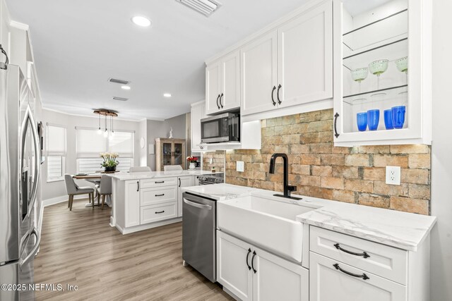 kitchen with white cabinets, visible vents, appliances with stainless steel finishes, and a sink