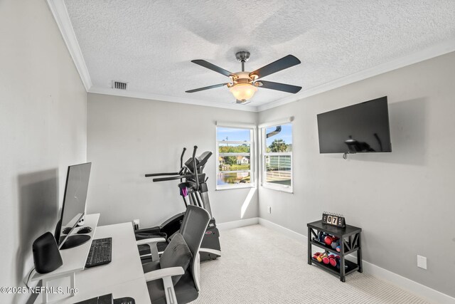 carpeted office with visible vents, ornamental molding, a textured ceiling, baseboards, and ceiling fan