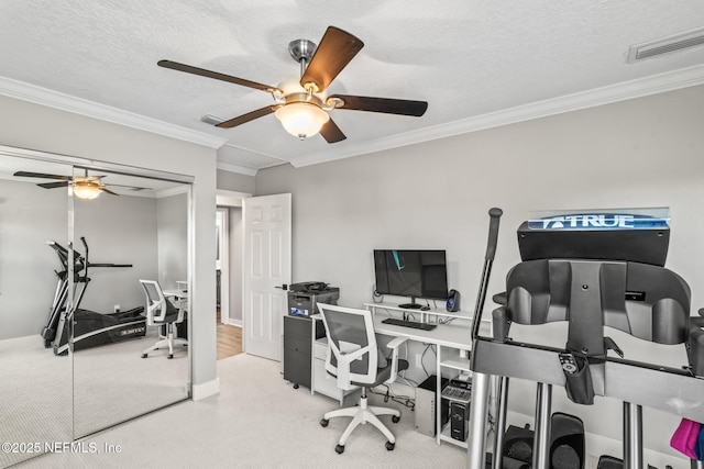 carpeted office featuring visible vents, a textured ceiling, and crown molding