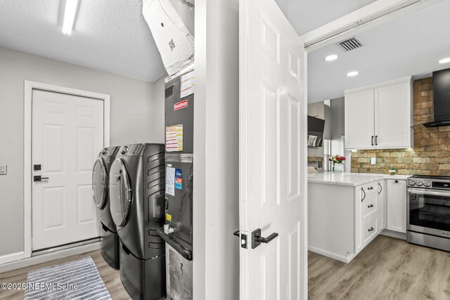 laundry room featuring visible vents, laundry area, recessed lighting, washing machine and dryer, and light wood-type flooring