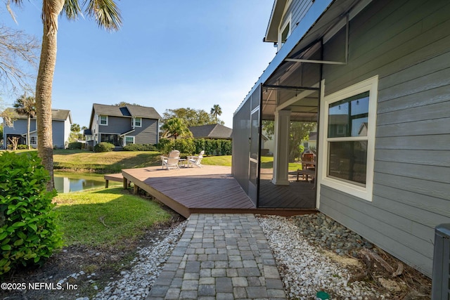 exterior space with a lanai and a deck with water view