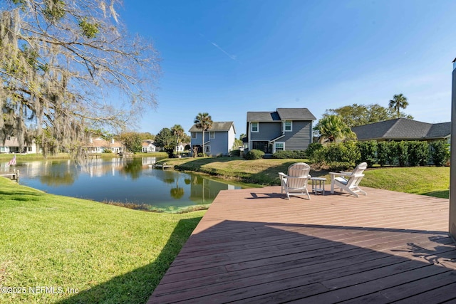 deck featuring a yard, a water view, and a residential view