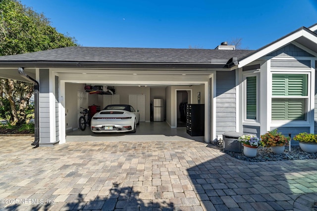 garage featuring decorative driveway