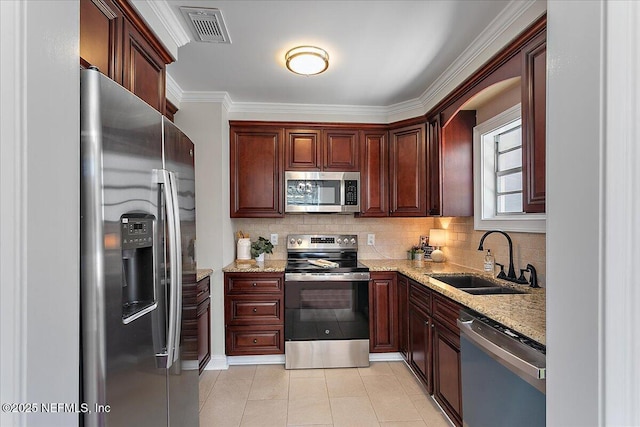 1282 Macarthur St, Jacksonville, FL 32205 - kitchen featuring stainless steel appliances, visible vents, backsplash, a sink, and light stone countertops