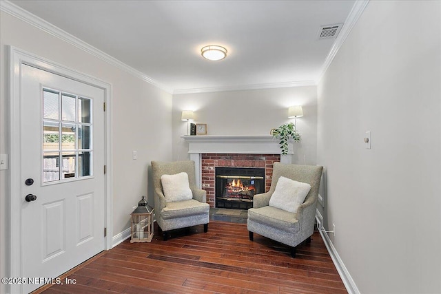1282 Macarthur St, Jacksonville, FL 32205 - living area featuring baseboards, visible vents, ornamental molding, hardwood / wood-style floors, and a brick fireplace
