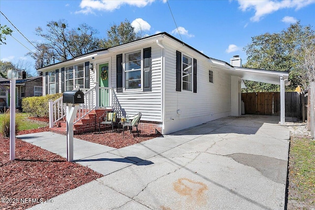 1282 Macarthur St, Jacksonville, FL 32205 - view of front of property featuring a carport, fence, and concrete driveway