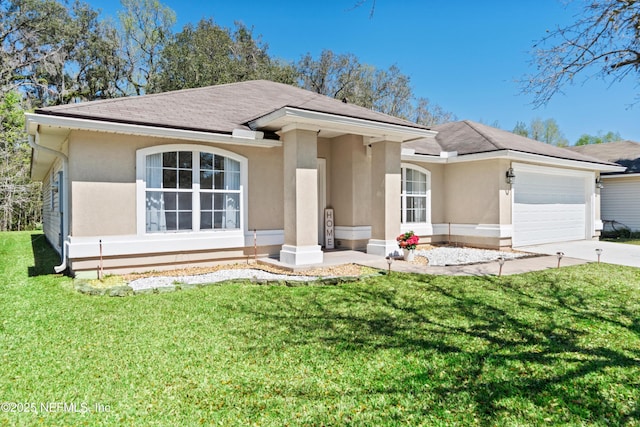 view of front facade with stucco siding, concrete driveway, a garage, and a front yard