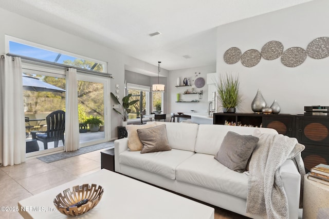 living room with light tile patterned floors and visible vents