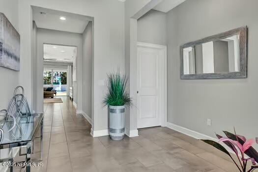 hall featuring baseboards