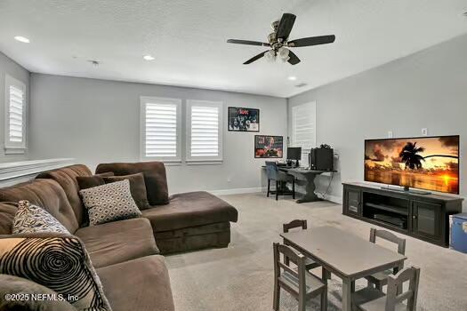 living room with baseboards, plenty of natural light, and carpet flooring