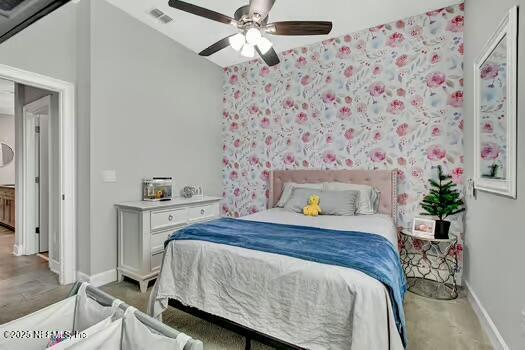 bedroom with baseboards, visible vents, and ceiling fan