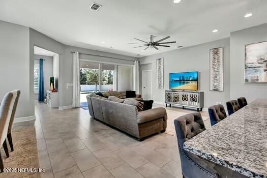 living room featuring ceiling fan, recessed lighting, visible vents, and baseboards